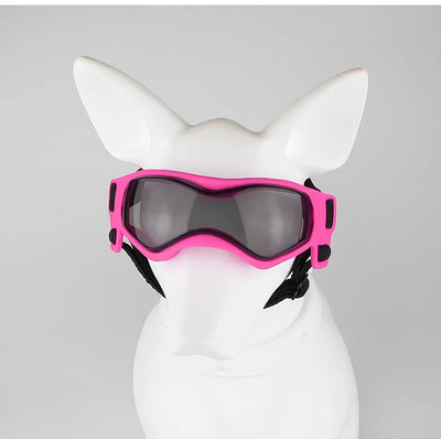 Pink adjustable pet goggles with dark lenses and black straps on white dog mannequin