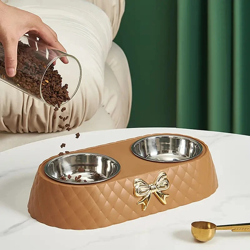 Aviour double stainless steel pet bowl with brown quilted base and gold bow detail for feeding pets