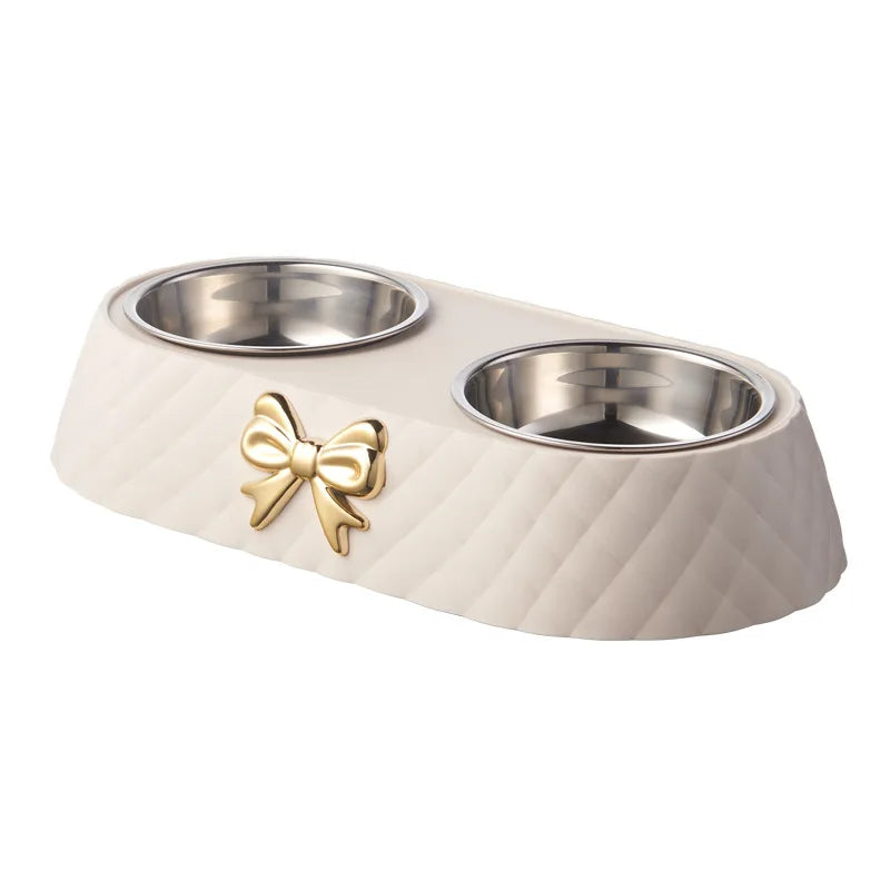 Aviour double stainless steel pet bowl with beige textured base and decorative gold bow