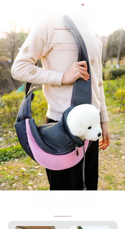 Aviour hands-free pet carrier bag in black and pink with mesh design carrying a small white dog outdoors