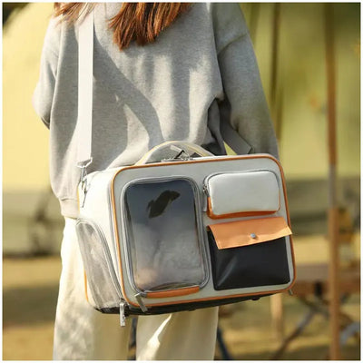 Aviour portable cat carrier on wheels with multiple pockets and transparent window carried by a person