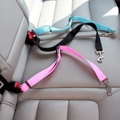 Aviour dog car seat belt for travel in blue black and pink colors laid on car seat